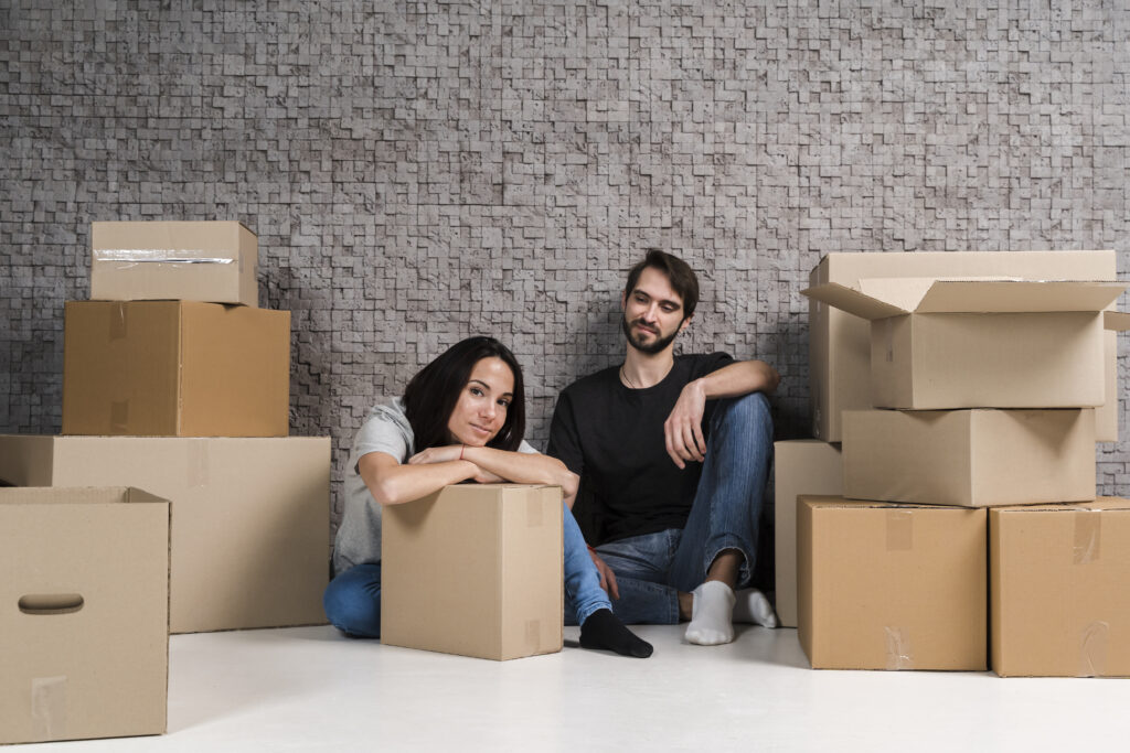 young man woman preparing boxes relocation